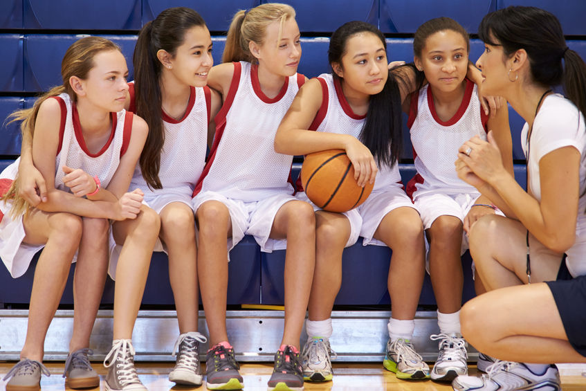 33478109 - coach of female high school basketball team gives team talk