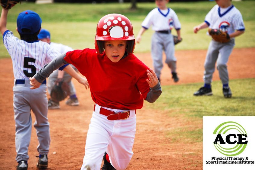 18765537 - youth little league baseball boy running bases.