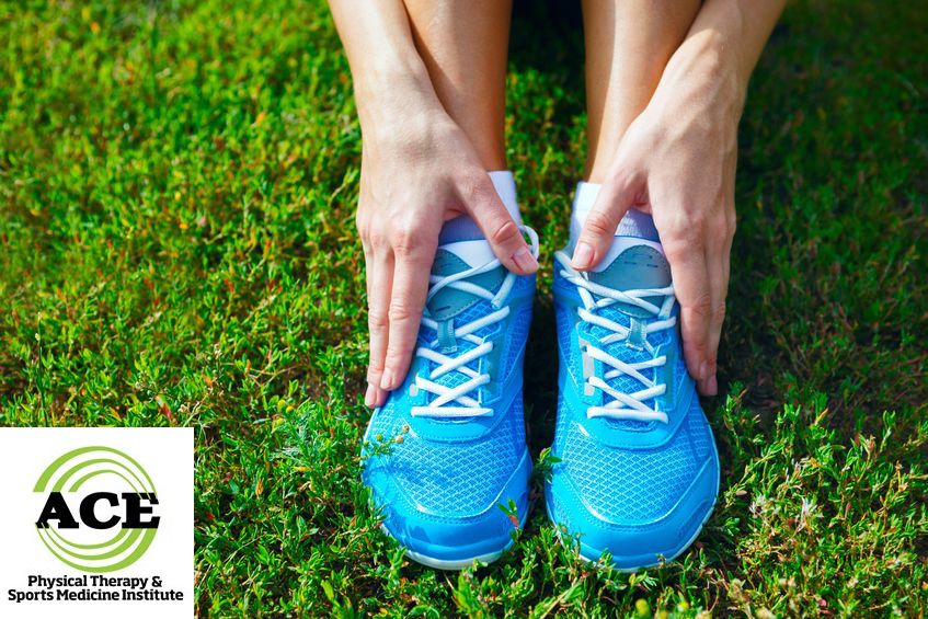 21233198 - closeup of running shoes on grass - concept image