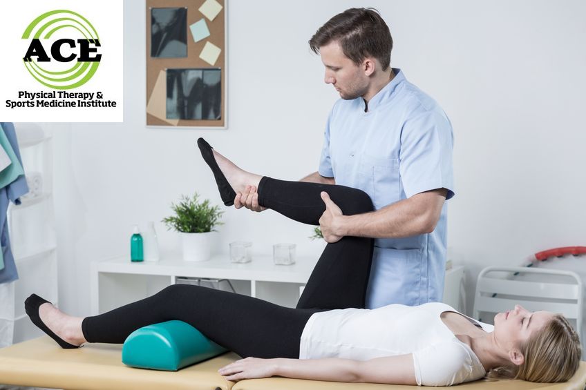 42784427 - male physiotherapist exercising with patient having knee pain