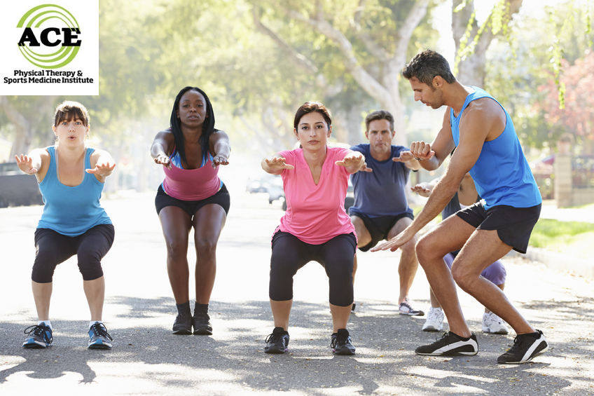 24490028 - group of people exercising street with personal trainer